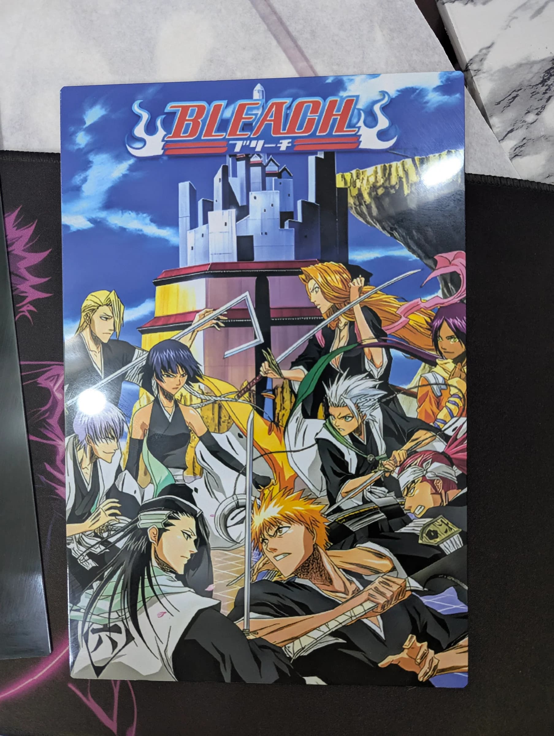 Metal poster of the Bleach anime series key art showing Ichigo Kurosaki and fellow Soul Reaper characters with swords drawn in front of a tower, with the Bleach logo